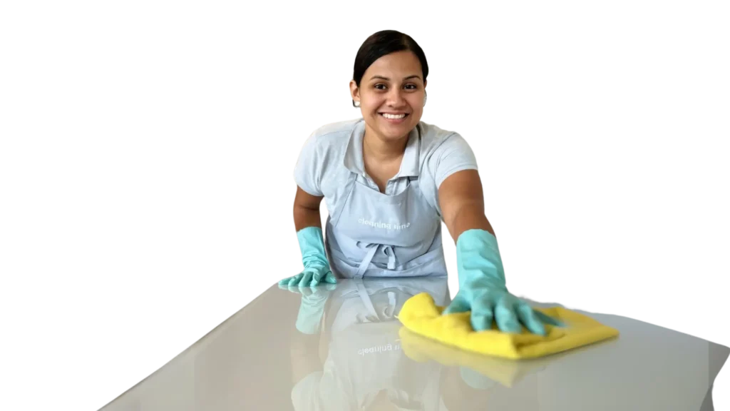 Smiling cleaner wiping glass with yellow cloth, wearing gloves and apron - professional cleaning service.